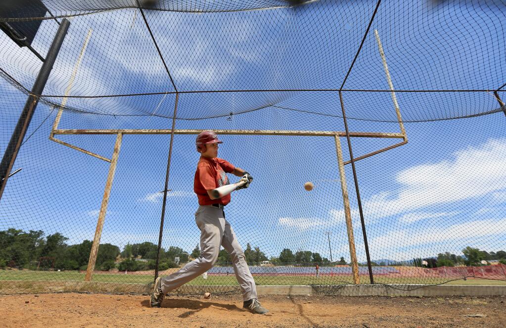 Clear Lake High School senior Jared Strate takes batting practice in the team's batting cage on the old football field (the goal post has been standing for 50 years or more) which has always doubled as the baseball field, Friday May 29, 2015 in Lakeport. (Kent Porter / Press Democrat)