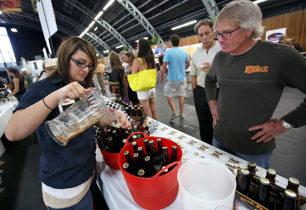 Bear Republic Brewing Company's Caitlin Tiedeman, left, pours beer for Stan Hockerson, of New Mexico, right, and Don Naumen, center, of Santa Rosa, during the Sonoma County Harvest Fair held at the Grace Pavillion at the Sonoma County Fairgrounds, Friday, October 3, 2014. (Crista Jeremiason/The Press Democrat)