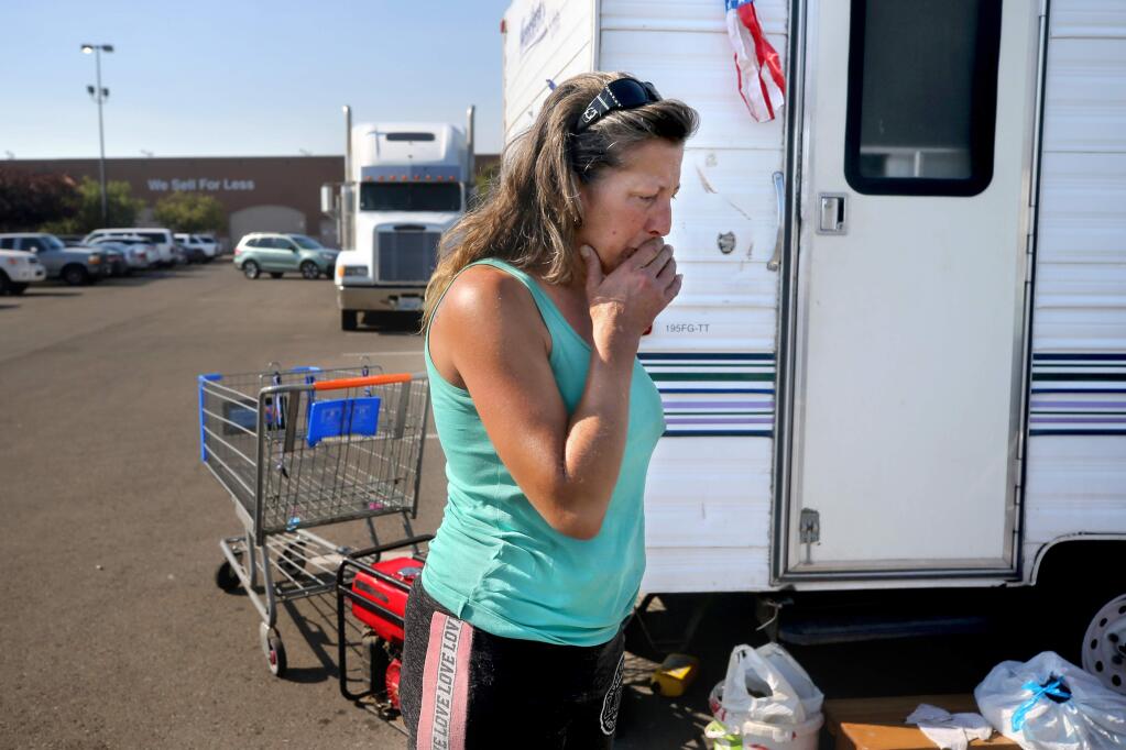 Tammy H., a Windsor resident and Kincade fire evacuee, becomes emotional as she stands in the Walmart parking lot in Rohnert Park on Tuesday, October 29, 2019. (BETH SCHLANKER/ The Press Democrat)