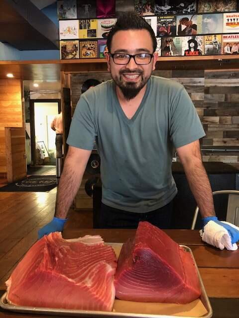 Aiki Terashima displays the fatty 'otoro,' left, and the half red meat and half fat 'chutoro' portions of his recently delivered 200-pound Blue Fin tuna.