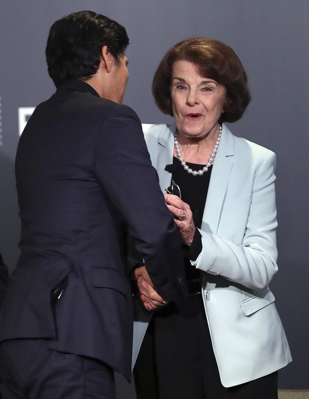 California Sen. Dianne Feinstein, D-Calif., reacts after receiving a kiss from California Sen. Kevin de Leon, D-Los Angeles, after a debate Wednesday, Oct. 17, 2018, in San Francisco. Feinstein shared the stage with an opponent for the first time since 2000 when she debated state Sen. Kevin de Leon.The two Democrats are facing off in the Nov. 6 election. (AP Photo/Ben Margot)