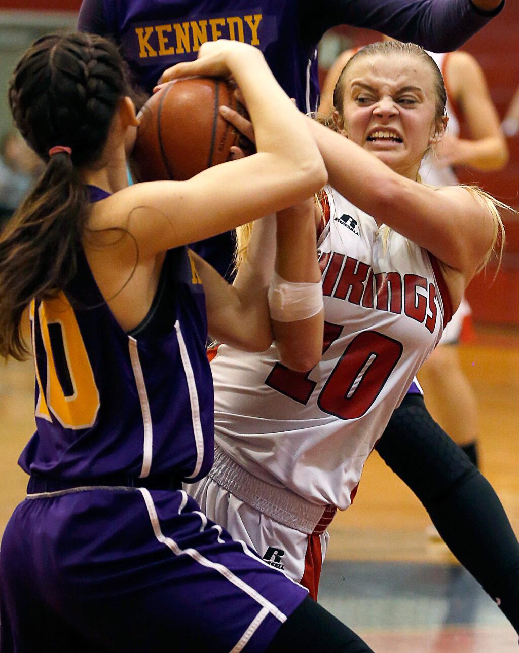 Montgomery's Shayla Newman (10), right, wrestles Kennedy's Raylene Hawkins (10) for ball possession during the first half of the NCS Division 2 girls basketball first round playoff game between Kennedy and Montgomery high schools in Santa Rosa, California on Tuesday, February 21, 2017. (Alvin Jornada / The Press Democrat)