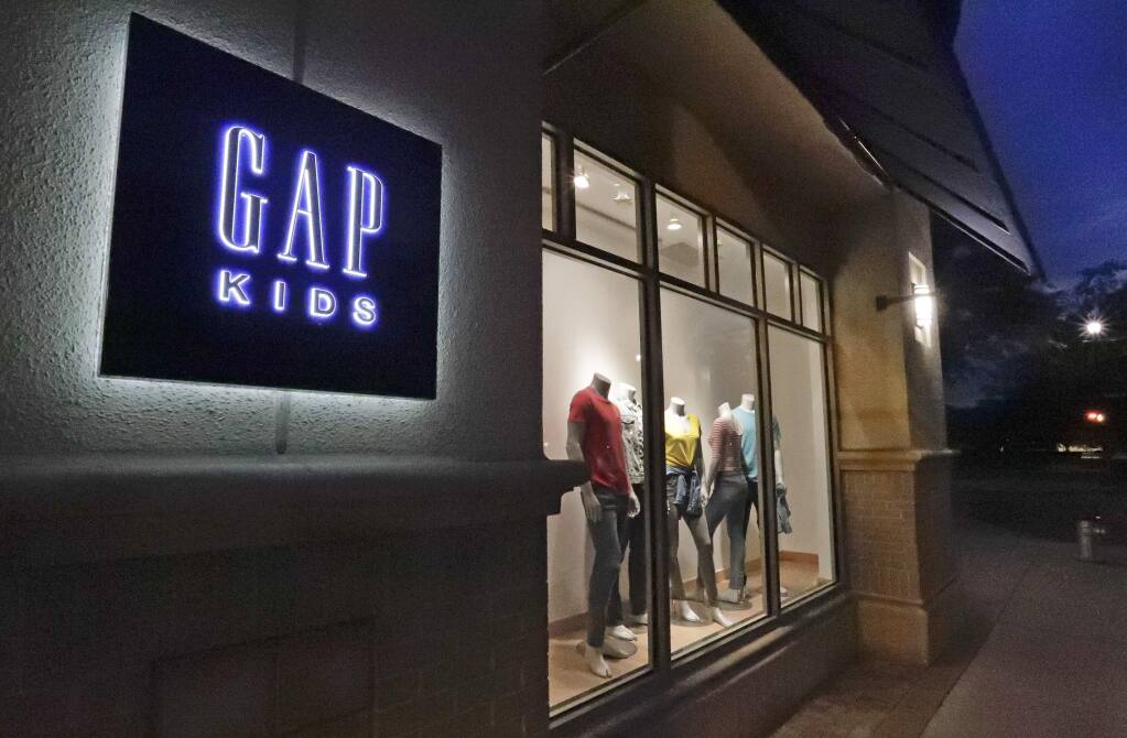FILE - This Aug. 23, 2018, file photo shows a window display at a Gap Kids clothing store in Winter Park, Fla. Gap is being sued for refusing to pay rent for stores temporarily closed during the coronavirus pandemic. Mall owner Simon Property Group filed a lawsuit in early June 2020, claiming the clothing retailer owes three months of rent, totaling $65.9 million. (AP Photo/John Raoux, File)