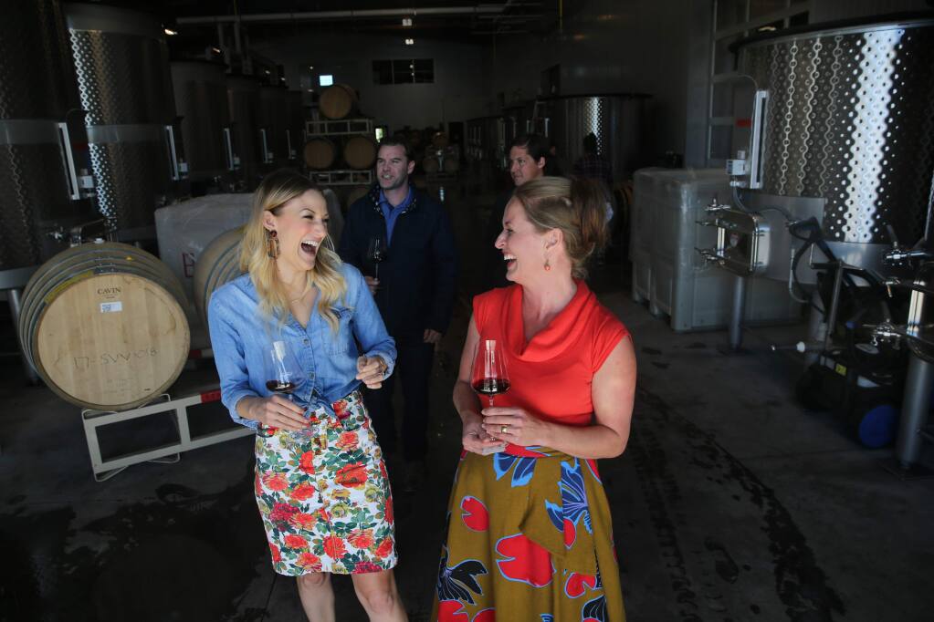 Hospitality manager Nicole Yasinsac, right, leads a tour with guests Katie Fay, left, a hospitality manager at Lambert Bridge Winery, Danny Fay, rear left, a general manager of Kanzler Family Vineyards, and winemaker William Weese, rear right, through the production area at Grand Cru Custom Crush in Windsor on Thursday, October 25, 2018. (BETH SCHLANKER/ The Press Democrat)
