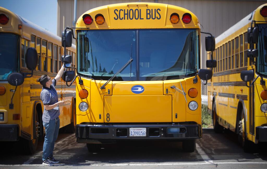 Petaluma, CA, USA. Tuesday, August 13, 2019._ Ashley Smith, a dispatcher and school bus driver for Petaluma City Schools Department of Transportation, prepares one of the school buses for the first day of school. (CRISSY PASCUAL/ARGUS-COURIER STAFF)