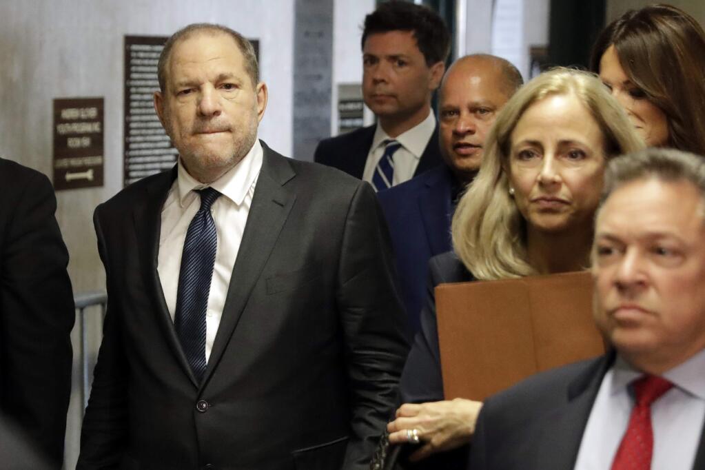 FILE - In this Thursday, July 11, 2019 file photo, Harvey Weinstein, left, arrives at court for a hearing related to his sexual assault case in New York. Harvey Weinstein is scheduled to appear in a New York City courtroom Friday, Dec. 6, 2019 for a pretrial hearing in his rape and sexual assault case. The hearing is one of many courts have scheduled across the state in advance of an overhaul of the state's rules for setting bail for criminal defendants. (AP Photo/Richard Drew, File)