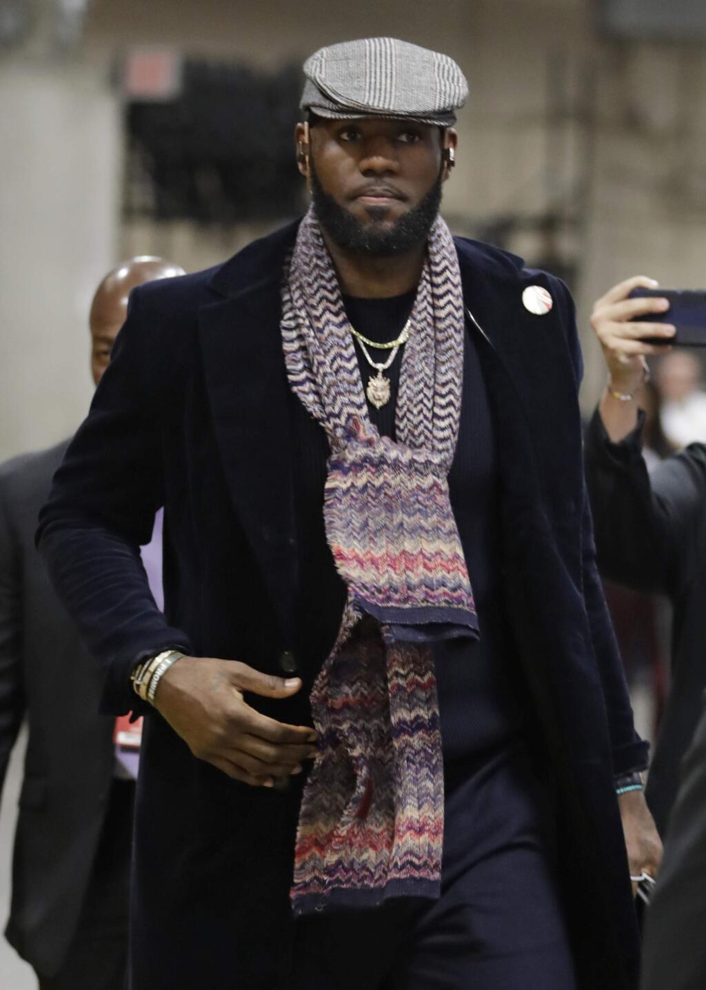Los Angeles Lakers' LeBron James enters the arena before an NBA basketball game against the Cleveland Cavaliers, Wednesday, Nov. 21, 2018, in Cleveland. (AP Photo/Tony Dejak)