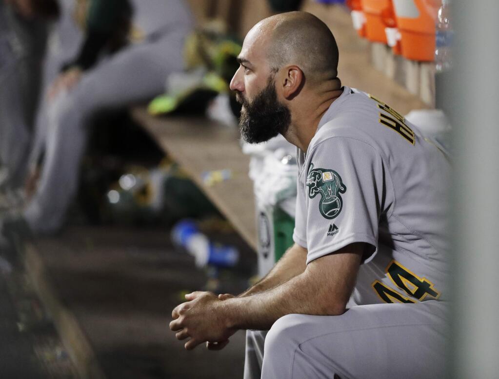 Oakland Athletics relief pitcher Chris Hatcher sits in the dugout following the seventh inning against the Seattle Mariners, Friday, April 13, 2018, in Seattle. The Mariners scored five runs during the inning. (AP Photo/Ted S. Warren)