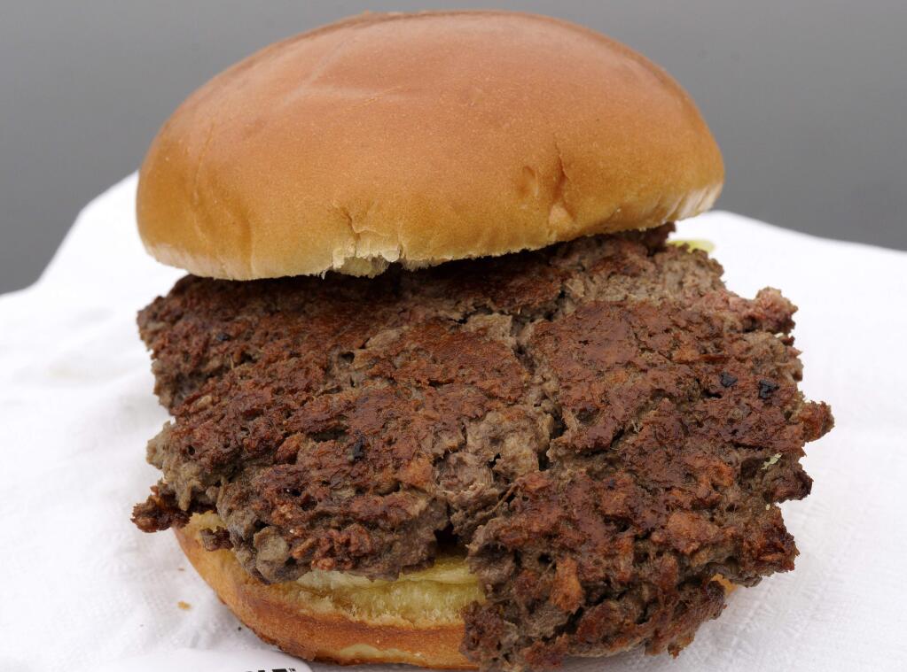 This Friday, Jan. 11, 2019 photo shows the 'Impossible Burger,' a plant-based burger made from wheat protein, coconut oil, potato protein and other ingredients in Bellevue, Neb. Released on Wednesday, Jan. 16, 2019, a report from a panel of nutrition, agriculture and environmental experts recommends a plant-based diet, based on previously published studies that have linked red meat to increased risk of health problems. (AP Photo/Nati Harnik)