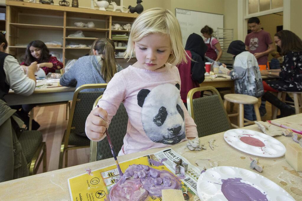 Elsa Payne, 4, was one of over fifty who went to the Sonoma Community Center on Friday, Nov. 10, to make and decorate hearts from clay that will adorn the Plaza at the official holiday lighting party on Saturday, Nov. 18. The hearts are emblematic of the community's gratitude towards the first responders to the recent Valley fires. (Photo by Robbi Pengelly/Index-Tribune)