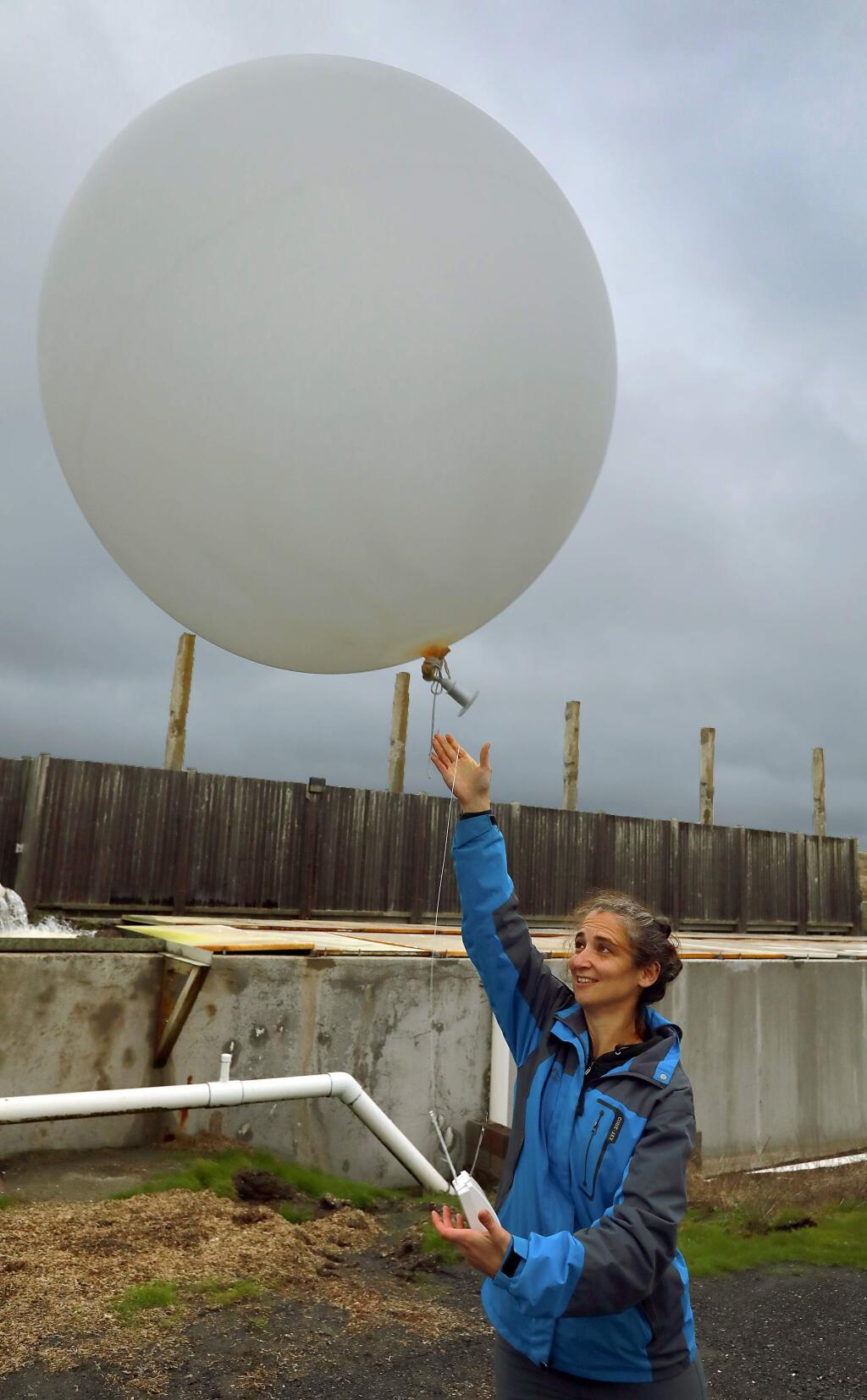 Anna Wilson, with the Scripps Institution of Oceanography, releases a weather balloon to study atmospheric rivers in the region. The balloon was released Sunday at 4 p.m. at the Bodega Marine Labs at the same time as another was released near Lake Mendocino in Ukiah. (John Burgess/The Press Democrat)