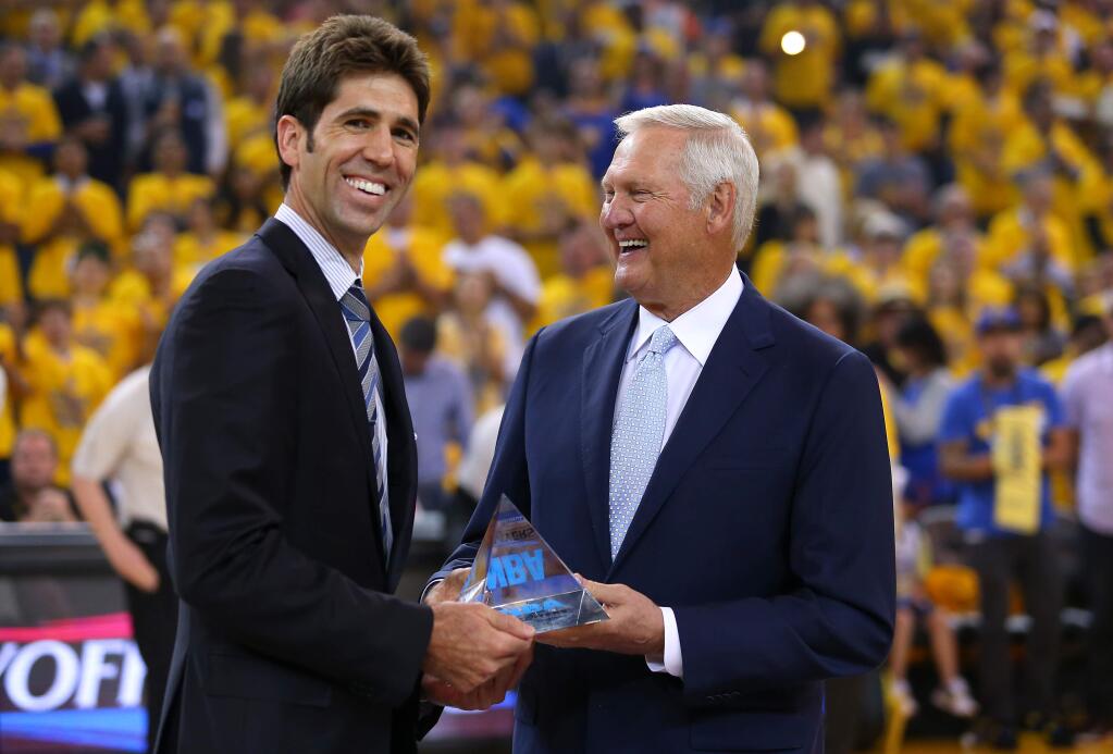 Golden State Warriors general manager Bob Myers, left, receives the NBA's executive of the year award from Jerry West before the start of Game 1 of the NBA Western Conference semifinals at Oracle Arena, in Oakland on Sunday, May 3, 2015. (Christopher Chung / The Press Democrat)