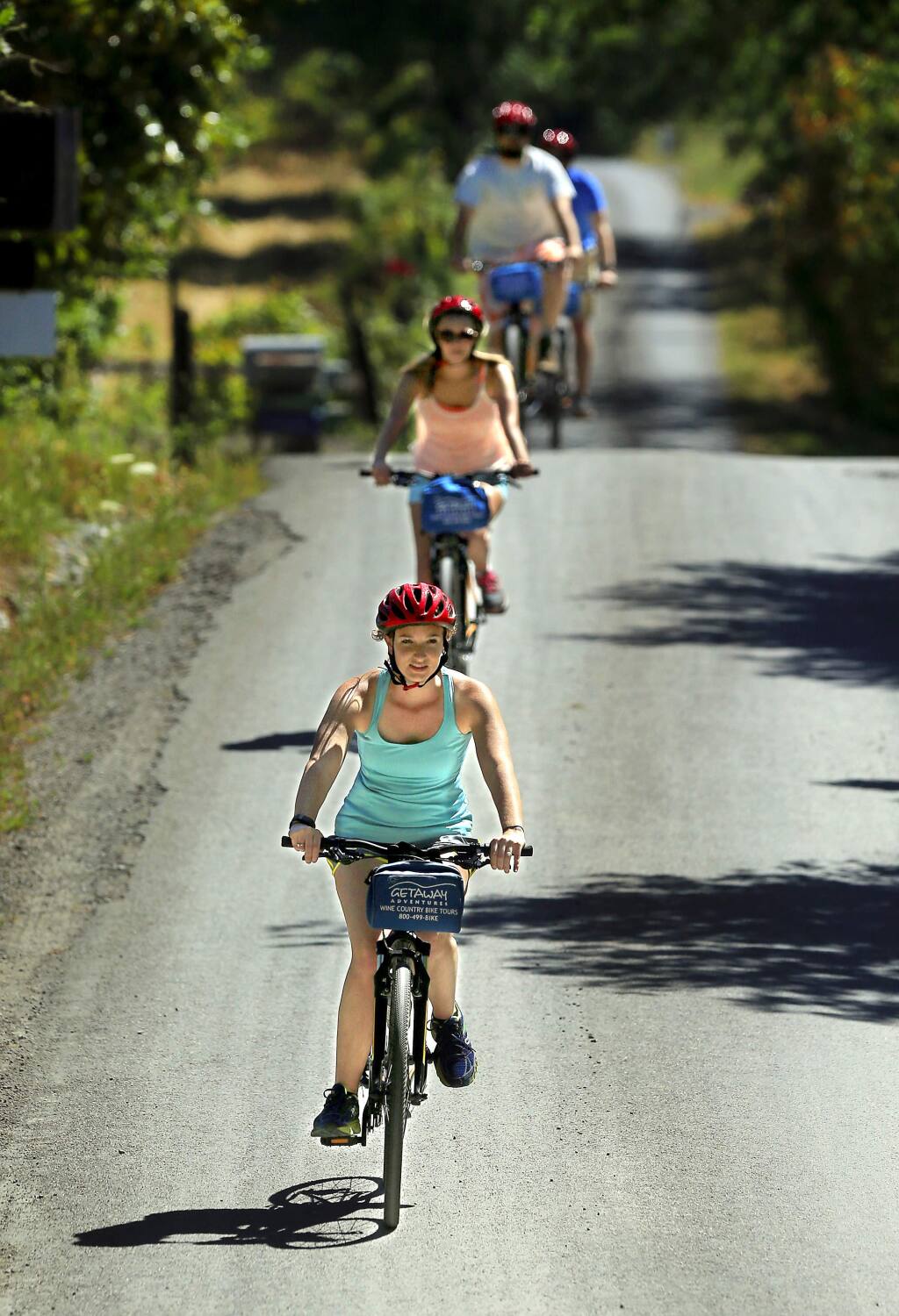 Sara Babineau leads a group of friends from Wisconsin on a bike ride to Iron Horse Vineyards on their pedal n' paddle trip with Gateway Adventures. (JOHN BURGESS/The Press Democrat)