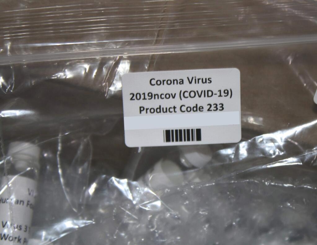 In this Thursday, March 12, 2020, photo released by the U.S. Customs and Border Protection (CBP), shows a package containing suspected counterfeit COVID-19 test kits arriving from the United Kingdom. CBP officers discovered six plastic bags containing various vials, while conducting an enforcement examination of a parcel manifested as 'Purified Water Vials' with a declared value of $196.81. A complete examination of the shipment, led to the finding of vials filled with a white liquid and labeled 'Corona Virus 2019nconv (COVID-19)' and 'Virus1 Test Kit'. The shipment was turned over to the U.S. Food and Drug Administration (FDA) for analysis. (U.S. Customs and Border Protection via AP)