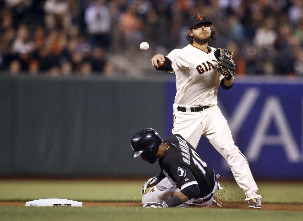 San Francisco Giants shortstop Brandon Crawford makes the force-out on Chicago White Sox' Alexei Ramirez (10) at second but cannot turn the double play on Conor Gillaspie at first during the fourth inning of a baseball game on Tuesday, Aug. 12, 2014, in San Francisco. (AP Photo/Tony Avelar)