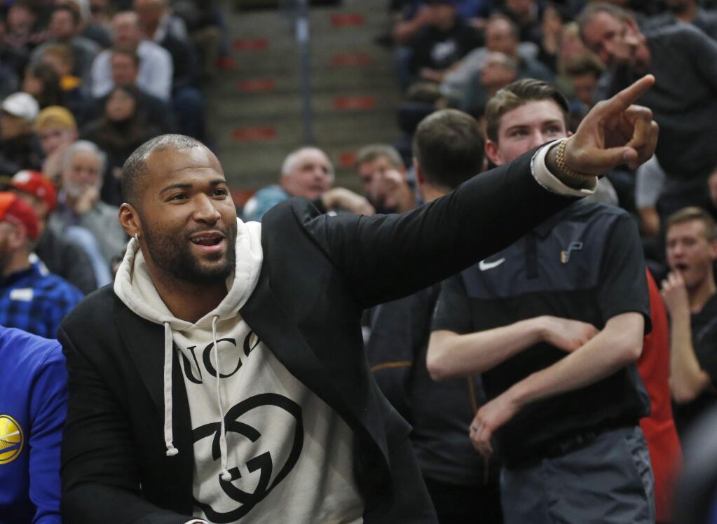 Golden State Warriors center DeMarcus Cousins points to Utah Jazz fans in the first half during a game against the Utah Jazz Wednesday Dec. 19, 2018, in Salt Lake City. (AP Photo/Rick Bowmer)