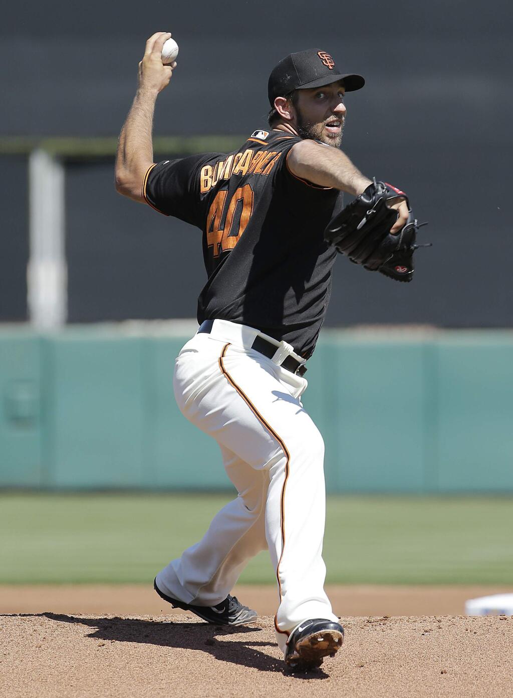San Francisco Giants starting pitcher Madison Bumgarner throws before the first inning of a spring training baseball game against the Oakland Athletics in Scottsdale, Ariz., Saturday, March 19, 2016. (AP Photo/Jeff Chiu)