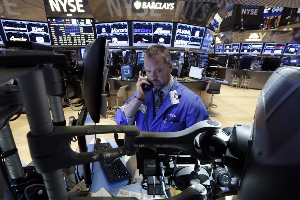 Trader Kevin Lodewick works on the floor of the New York Stock Exchange before the opening bell, Monday, Aug. 24, 2015. World stock markets plunged on Monday after China's main index sank 8.5 percent, its biggest drop since the early days of the global financial crisis, amid deepening fears over the health of the world's second-largest economy. (AP Photo/Richard Drew)