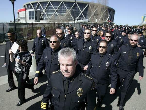 Brian Masterson, Director of Public Saftery for the city of Rohnert Park leads his officers into the Oakland Colusium on Friday March 27, 2009, after the Oracle Arena was filled to capacity for the memorial service for the four Oakland police officers who were killed. Scott Manchester / The Press Democrat