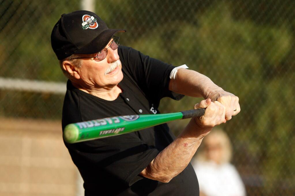 Gerry Savela, 75, swings to re-enact his lone at-bat with a Rohnert Park women's softball team at Sunrise Park on Thursday, July 12, 2018. (Alvin Jornada / The Press Democrat)