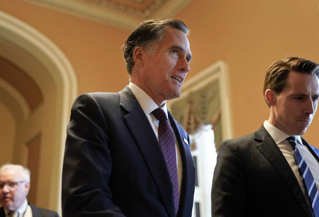Sen.-elect Mitt Romney, R-Utah walks down a Capitol Hill hallway on Wednesday. (PABLO MARTINEZ MONSIVAIS / Associated Press)