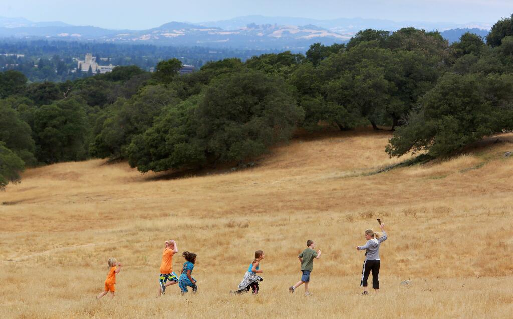 The Wright family of Santa Rosa heads down the hill on a trail in the Taylor Mountain Regional Park and Open Space Preserve. (JOHN BURGESS / PD FILE)