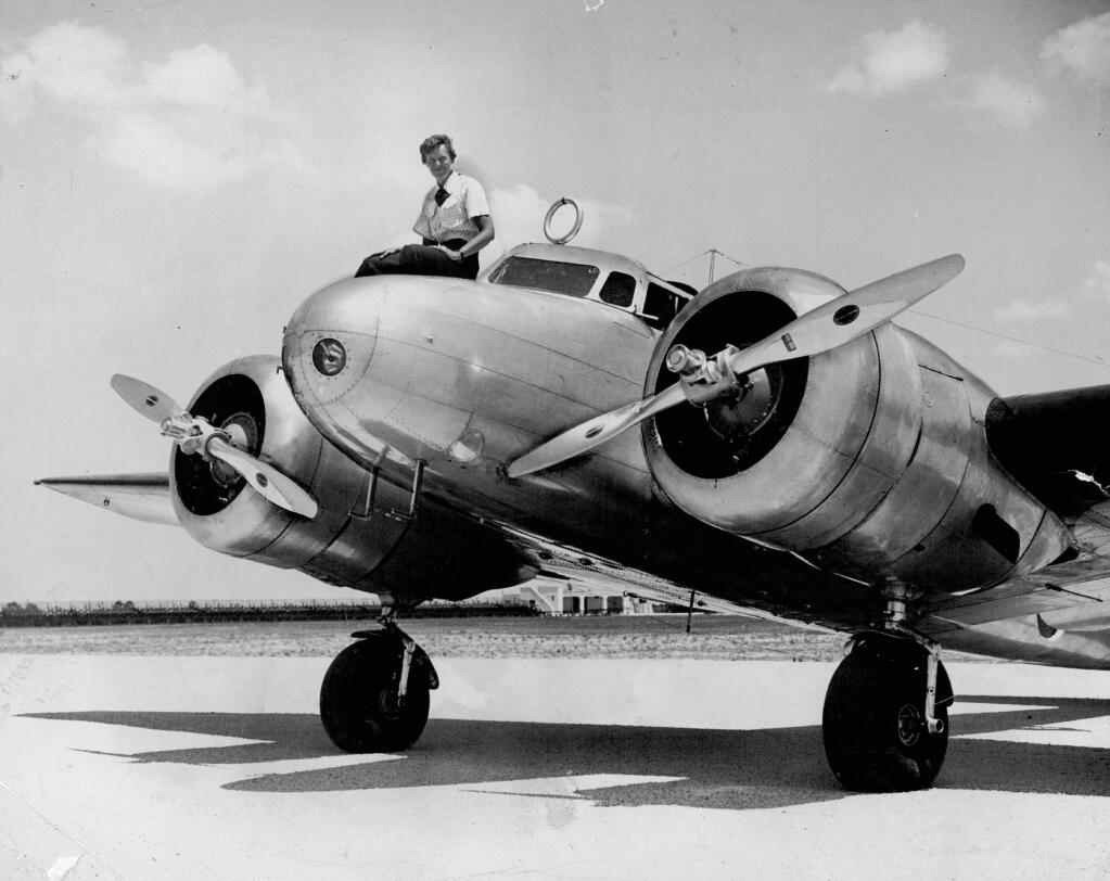 This 1937 photo shows Amelia Earhart before takeoff in Miami for an attempted round-the-world flight. Earhart and her navigator, Fred Noonan, disappeared in the South Pacific in July 1937, while on one of the last legs of that journey. (The Miami Herald via AP)