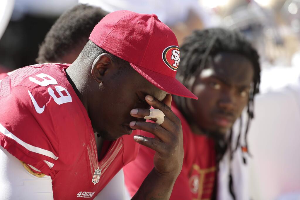 FILE - In this Aug. 17, 2014, file photo, San Francisco 49ers linebacker Aldon Smith (99) sits on the sideline during the second half of an NFL preseason football game against the Denver Broncos in Santa Clara, Calif. Aldon Smith has been suspended for nine games by the NFL after a series of off-field legal issues. A statement Friday, Aug. 29, 2014, from the league said Smith had violated the NFLs substance abuse and personal conduct policies. (AP Photo/Marcio Jose Sanchez)