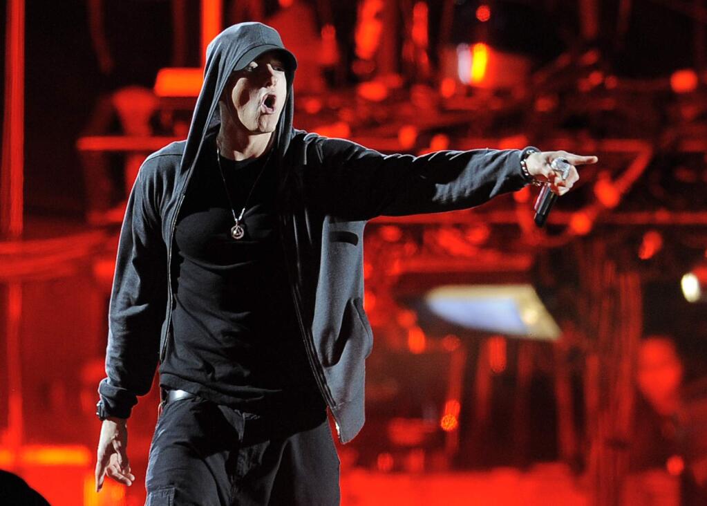 This April 15, 2012 file photo shows Eminem performing at the 2012 Coachella Valley Music and Arts Festival in Indio, Calif. Eminem, Kings of Leon and Outkast will headline this year's Lollapalooza music festival on Aug. 1-3, 2014, in Chicago. (AP Photo/Chris Pizzello, File)