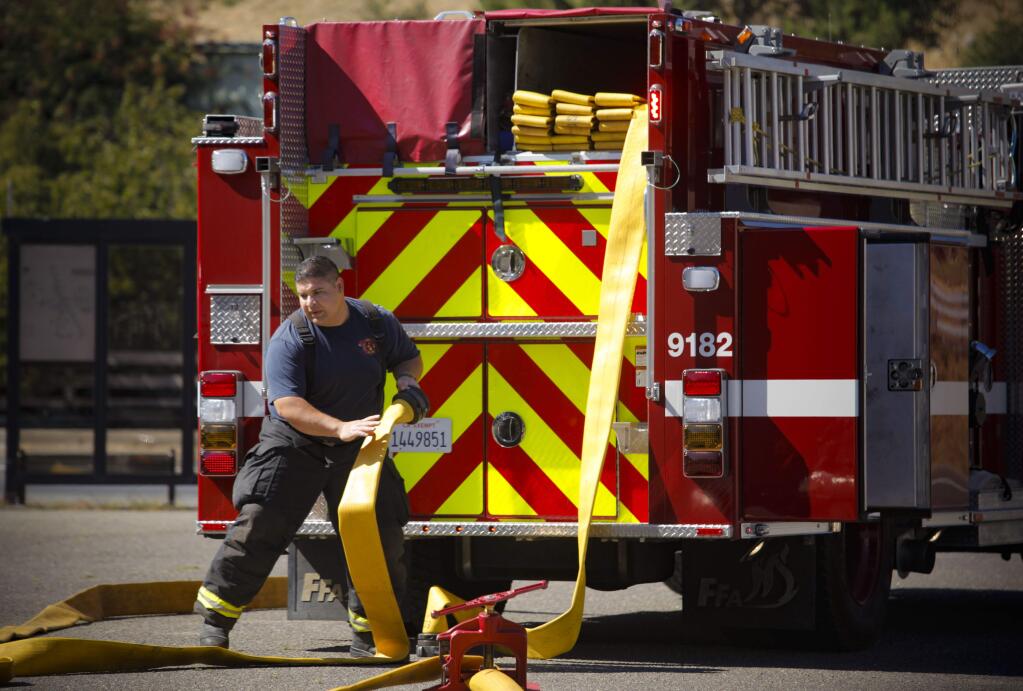 Enrique Ruiz, an engineer at the Rancho Adobe Fire District works on a training exercise at the station in Penngrove. A ballot measure to obtain more money for the Rancho Adobe Fire District is in the November ballot. (CRISTINA PASCUAL/ARGUS-COURIER STAFF)