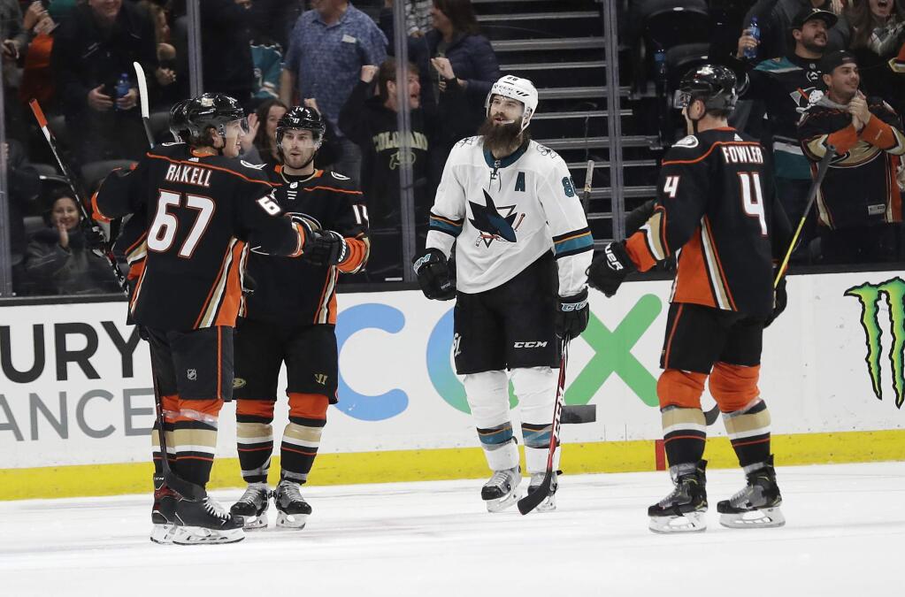 The Anaheim Ducks' Rickard Rakell, left, celebrates his goal with teammates as the San Jose Sharks' Brent Burns, second from right, skates past during the third period, Friday, March 22, 2019, in Anaheim. (AP Photo/Marcio Jose Sanchez)