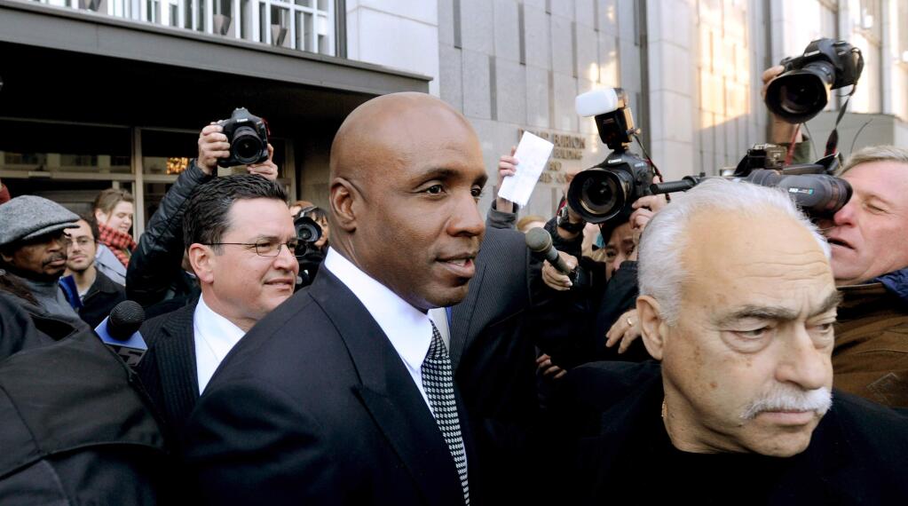 File - In this Dec. 16, 2011 file photo, former baseball player Barry Bonds leaves federal court after being sentenced for obstructing justice in a government steroids investigation in San Francisco. Nearly 11 years after Bonds testified before a grand jury investigating the illegal distribution of performance-enhancing drugs, a group of judges will hear arguments Thursday, Sept. 18, 2014, on whether baseballís career home-run leader should have his obstruction of justice conviction thrown out. (AP Photo/Noah Berger, File)