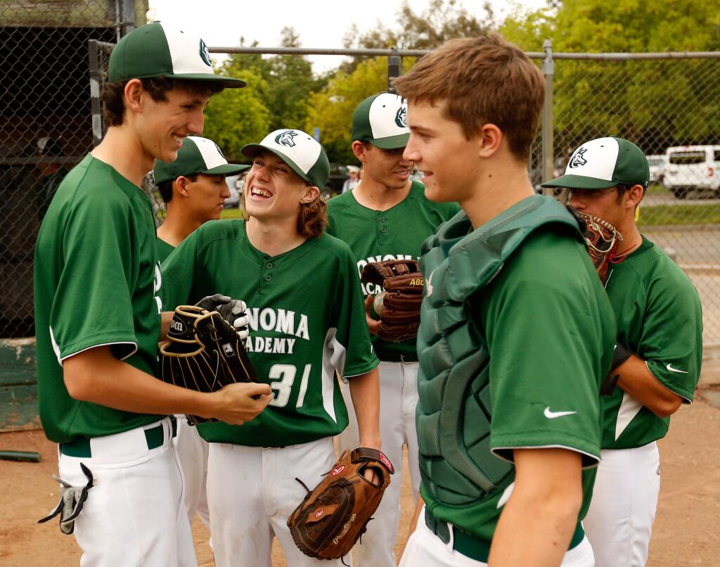 Sonoma Academy's Caden Zolezzi, left, and Benjamin Vogel (31) share a laugh before the team works toward a fifth consecutive no-hitter during their game aganst Rincon Valley Christian School at Doyle Park in Santa Rosa, California, on Tuesday, April 19, 2016. (Alvin Jornada / The Press Democrat)