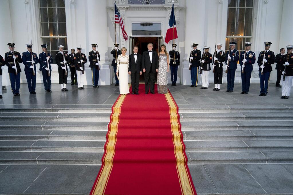President Donald Trump, first lady Melania Trump, French President Emmanuel Macron and his wife Brigitte Macron, pose for photographs as they arrive for a State Dinner on the North Portico at the White House in Washington, Tuesday, April 24, 2018. (AP Photo/Andrew Harnik)