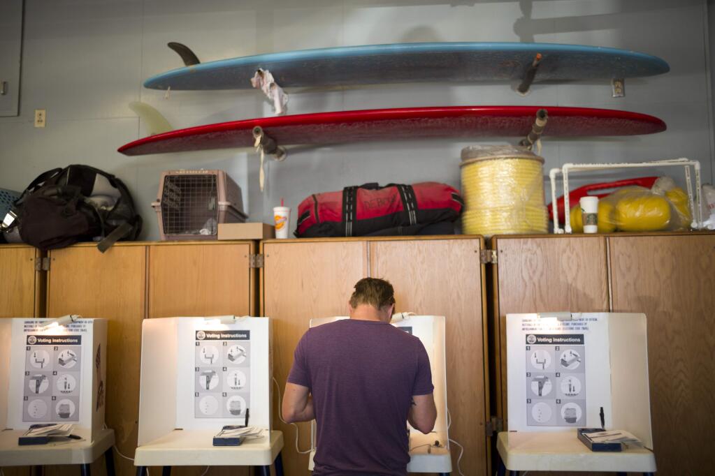 Billy Tolson casts his vote at the Venice Beach lifeguard headquarters Tuesday, Nov. 8, 2016, in Los Angeles. (AP Photo/Jae C. Hong)