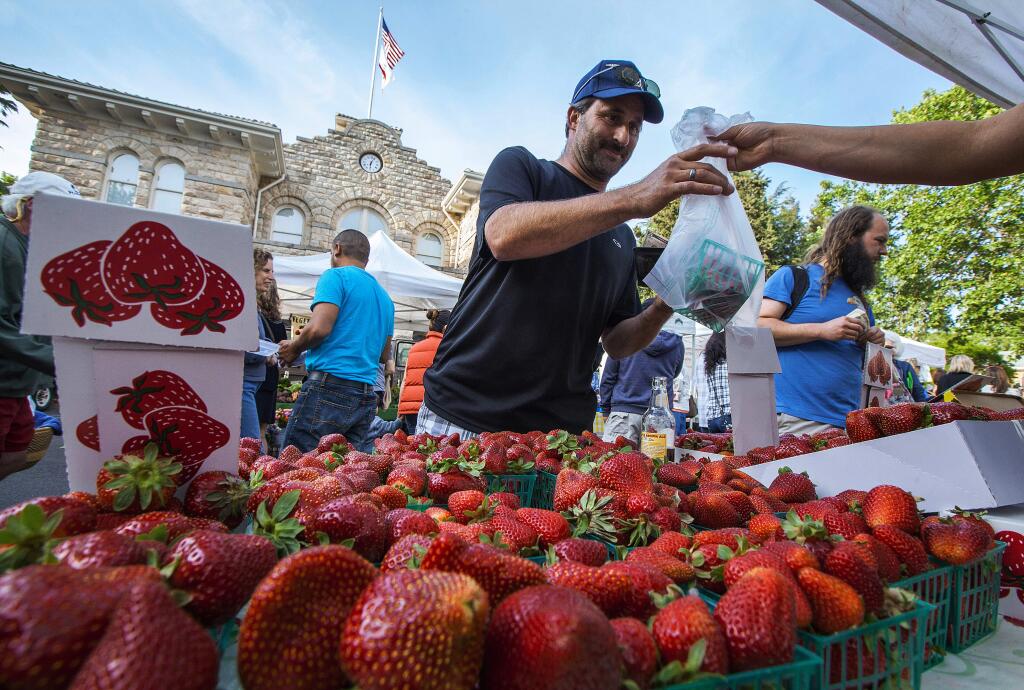 Jerome Baker treated himself to some fresh fruit from the Tuesday Night Market. (Robbi Pengelly/Index-Tribune)