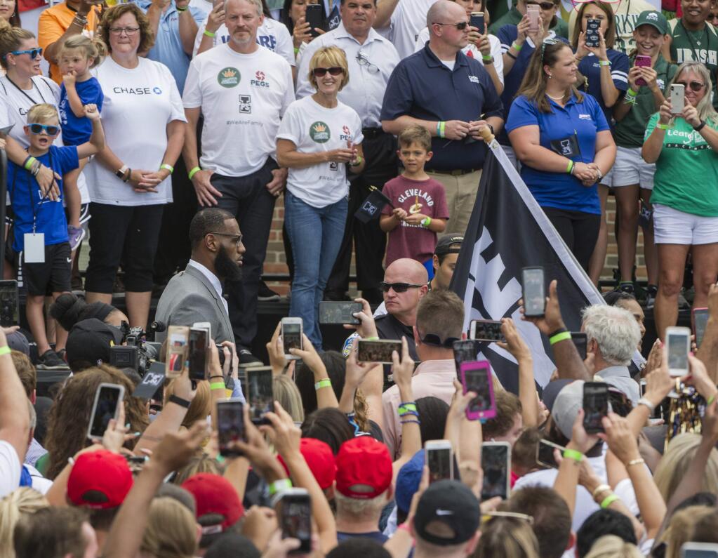 LeBron James walks past the crowd before speaking at the opening ceremony for the I Promise School in Akron, Ohio, Monday, July 30, 2018. The I Promise School is supported by the The LeBron James Family Foundation and is run by the AkronPublic Schools. (AP Photo/Phil Long)
