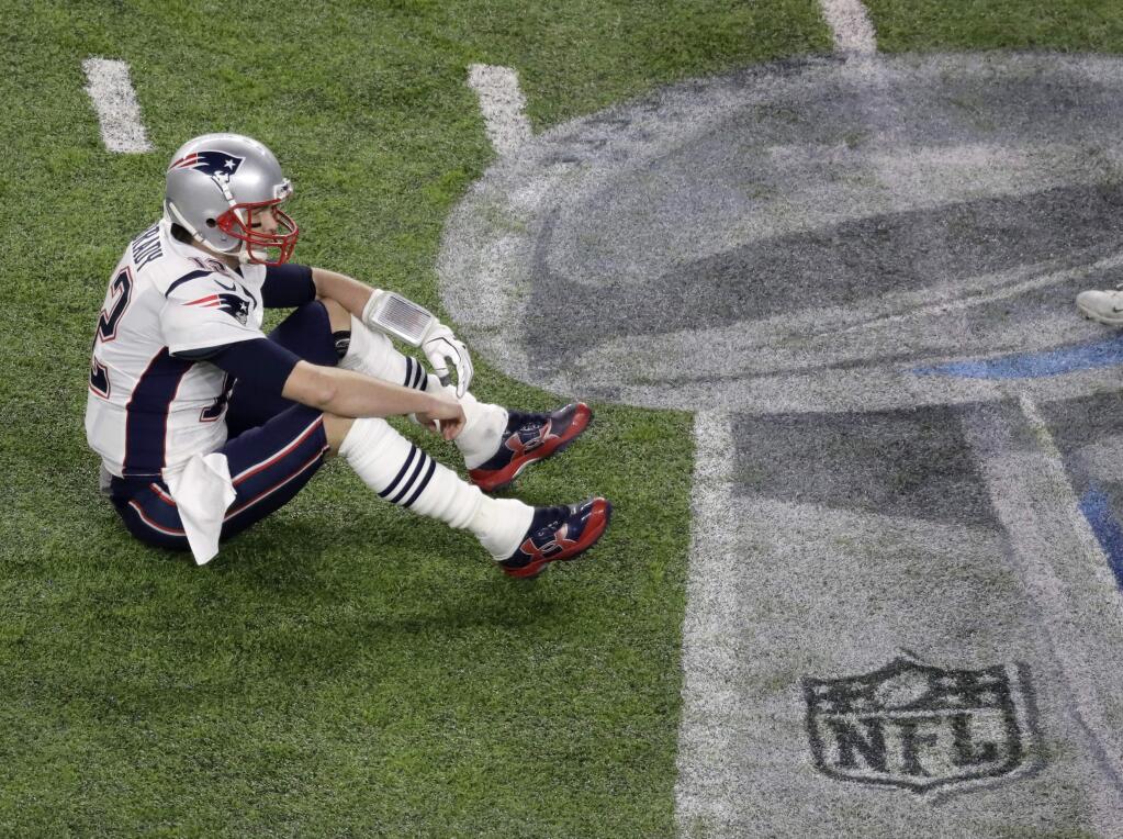 New England Patriots quarterback Tom Brady sits on the field after fumbling against the Philadelphia Eagles during the second half of Super Bowl 52 Sunday, Feb. 4, 2018, in Minneapolis. (AP Photo/Eric Gay)