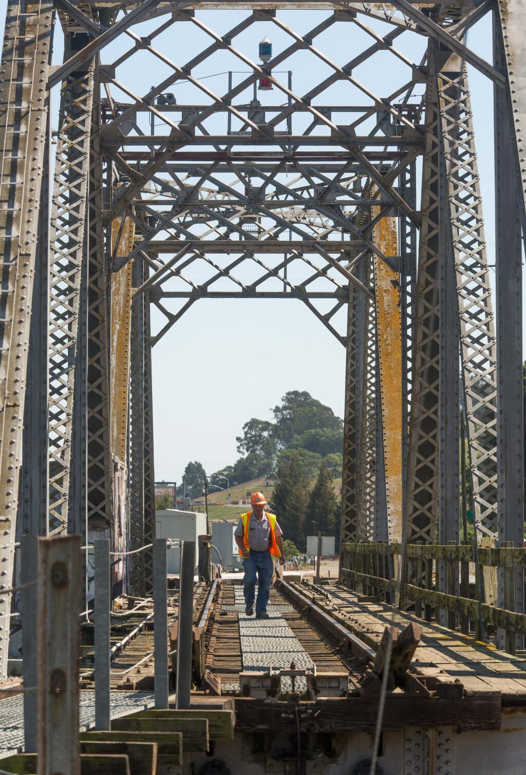 Gregg Evensen walks along railroad tracks lining the Haystack bridge in Petaluma on Friday, April 3, 2015. (JEREMY PORTJE / FOR THE PRESS DEMOCRAT)