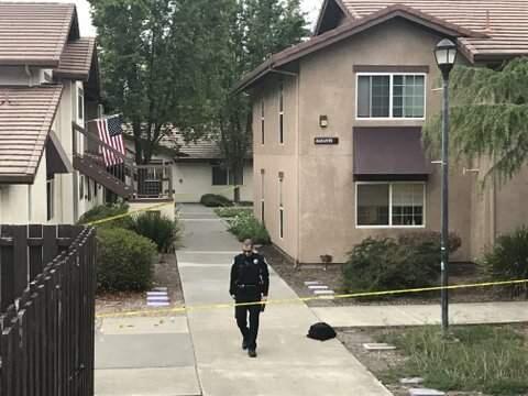 A Cotati police officer walks through the area where a 'student-aged' resident of the Alicante housing area in Sauvignon Village on the Sonoma State University campus was fatally stabbed on Sunday, May 13, 2018. (BETH SCHLANKER/ PD)