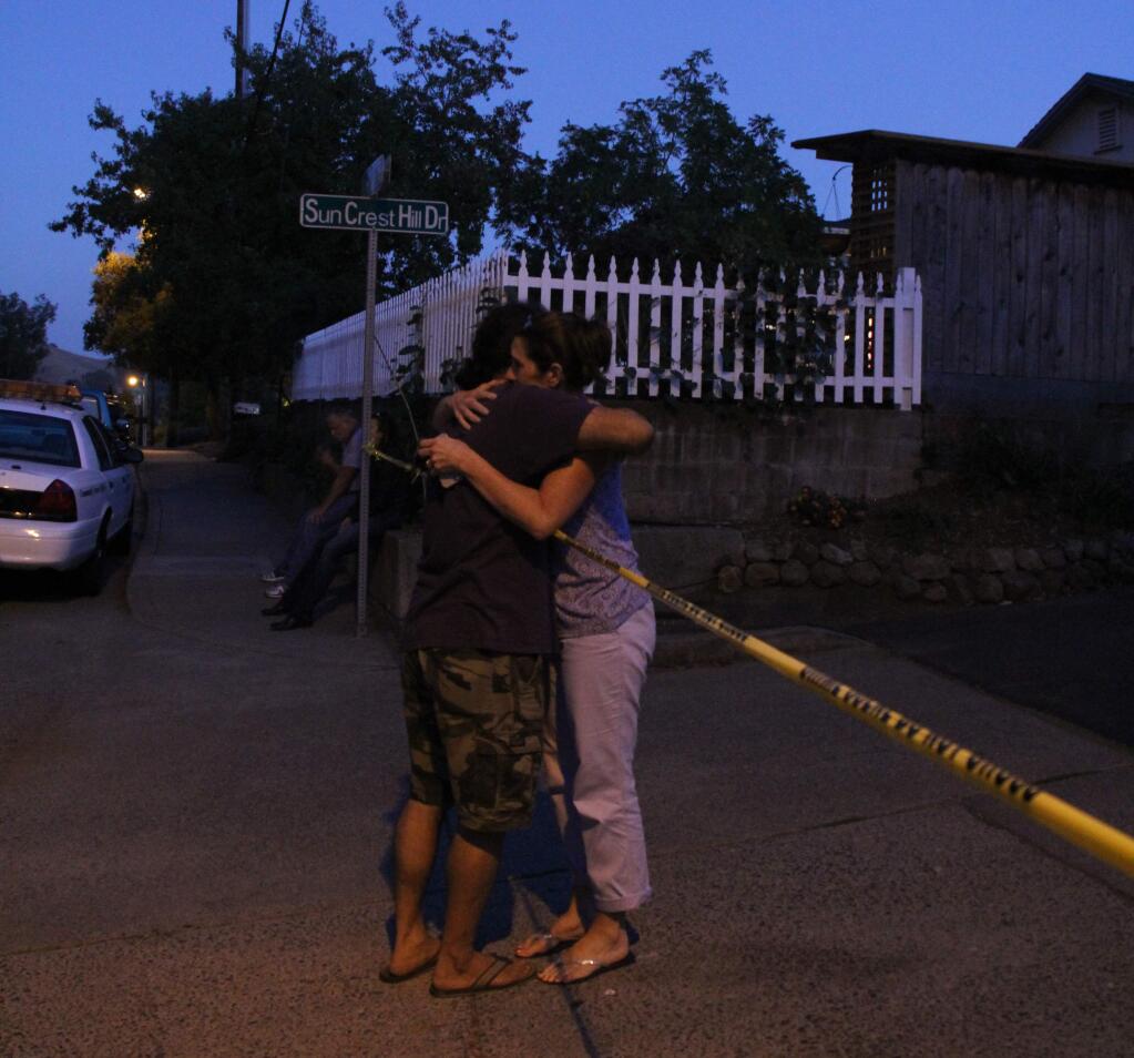 Neighbors hug over police tape following the murder of a resident on Suncrest Hill Drive on Sept. 10, 2014 (VICTORIA WEBB/FOR THE ARGUS-COURIER)