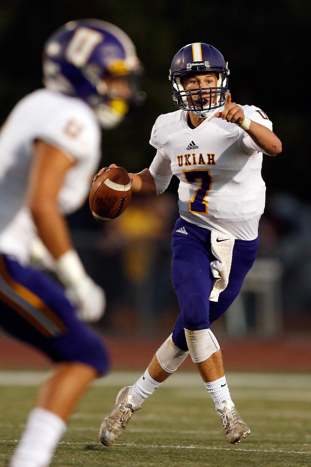 Ukiah quarterback Nate Johnson looks to pass as he scrambles out of the pocket during the first half between Ukiah and Santa Rosa high schools in Santa Rosa on Friday, Aug. 31, 2018. (Alvin Jornada / The Press Democrat)