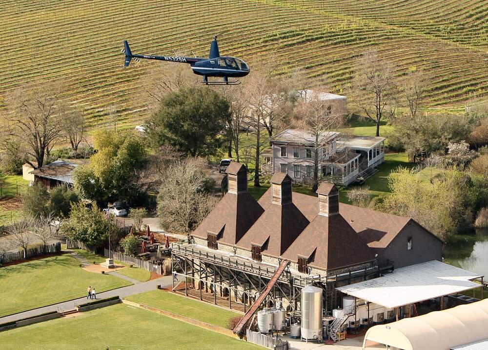 An R-44 Robinson helicopter owned by Sonoma Helicopter flies over Hop Kiln Winery. Nearby residents complained of noise after the company began wine tasting flights to and from the winery.