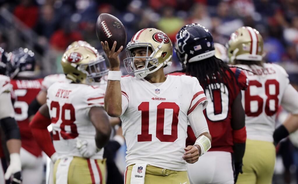 San Francisco 49ers quarterback Jimmy Garoppolo, center, smiles after a play during the second half against the Houston Texans Sunday, Dec. 10 in Houston. (AP Photo/David J. Phillip, File)