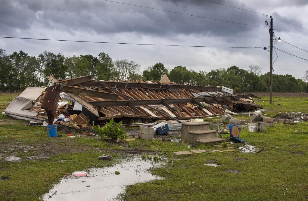 The remains of a trailer lie where a woman and her 3-year-old daughter were killed during a severe storm, in Breaux Bridge, La., Sunday, April 2, 2017. (Lucius Fontenot/The Daily Advertiser via AP)