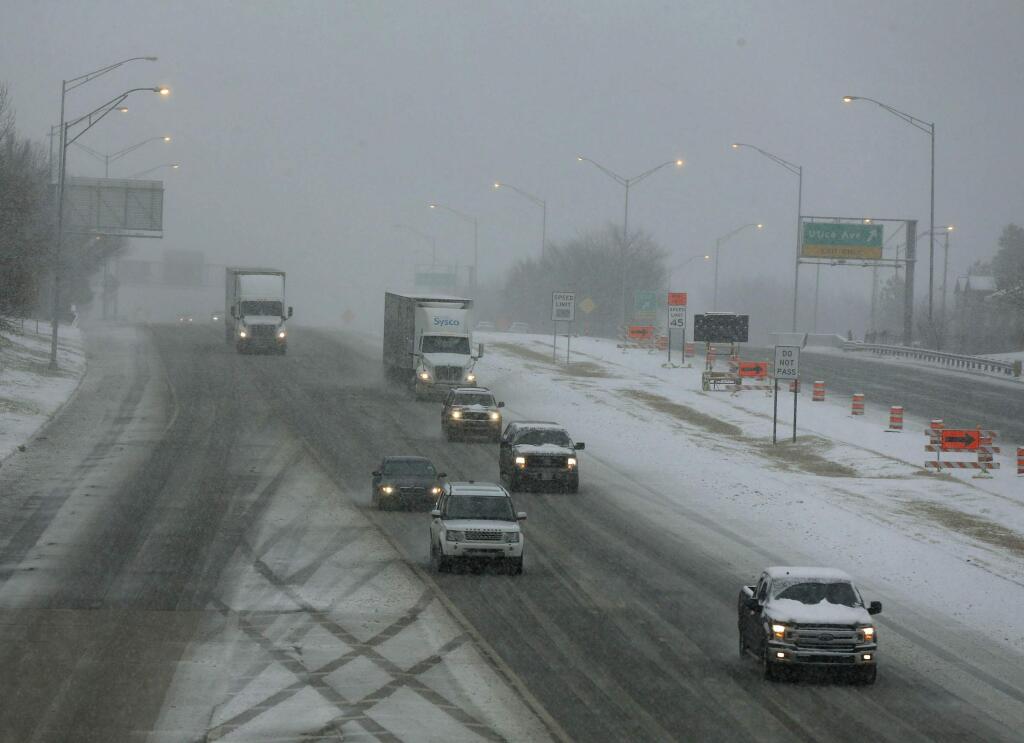 Traffic makes it way on the Broken Arrow Expressway headed West in the snow in Tulsa, Okla., Wednesday, Feb. 5, 2020. (Stephen Pingry/Tulsa World via AP)