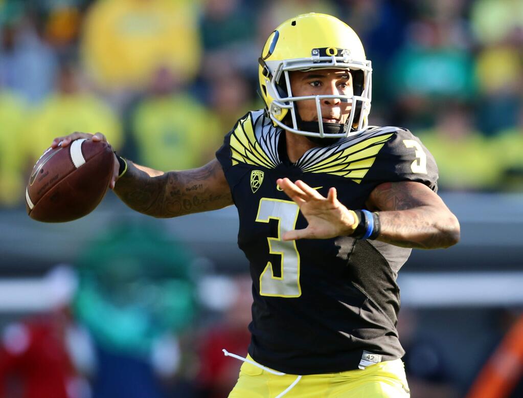 In this Sept. 5, 2015, file photo, Oregon quarterback Vernon Adams Jr. looks to pass during the first half of agame against Eastern Washington in Eugene, Ore. Adams, a transfer who was deemed Oregon's starter just prior to the start of the season, has been struggling since he broke his right index finger in the season opener against his former team, Eastern Washington. (AP Photo/Ryan Kang, File)