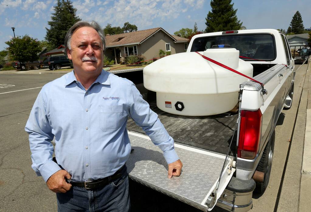 Healdsburg City Councilman Gary Plass bought a 300-gallon container for hauling highly treated recycled water from the sewage treatment plant at no charge to city residents for use in their landscaping. (JOHN BURGESS / The Press Democrat)