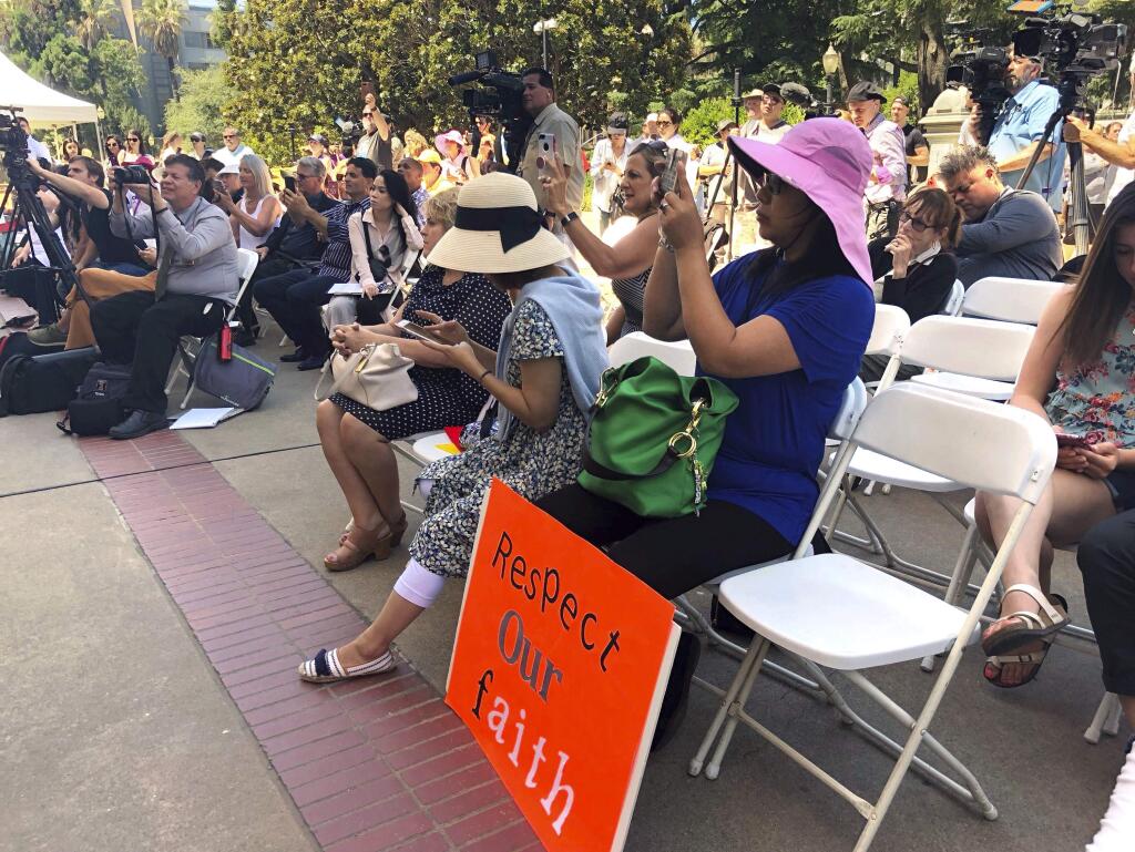 Opponents of a California bill to declare gay conversion therapy a fraudulent practice gather at a rally outside the Capitol as the Senate holds a hearing on the matter inside in Sacramento, Calif., Tuesday, June 12, 2018. Opponents said Tuesday the legislation could infringe on their religious freedom. (AP Photo/Sophia Bollag)