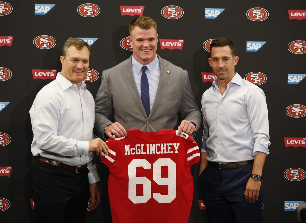 San Francisco 49ers general manager John Lynch, left, introduces first-round draft pick Mike McGlinchey, center, with coach Kyle Shanahan, right, during a news conference, Friday, April 27, 2018, in Santa Clara. (AP Photo/Josie Lepe )